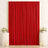 Elegant red velvet curtain backdrop with white floral arrangements and candles