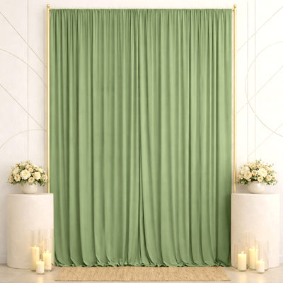 Green wedding backdrop with floral pedestals, candles, and elegant drapery