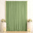 Green wedding backdrop with floral pedestals, candles, and elegant drapery