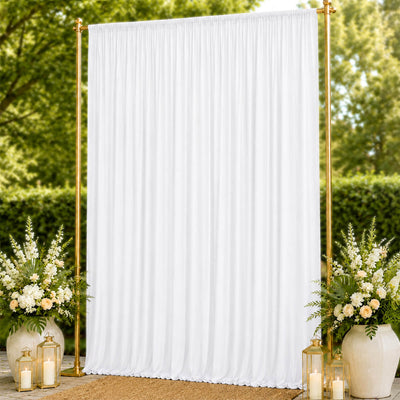 White wedding backdrop curtain with gold stand and floral decor outdoors