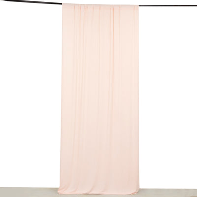 Soft blush pink sheer curtain hanging from a black rod on white background