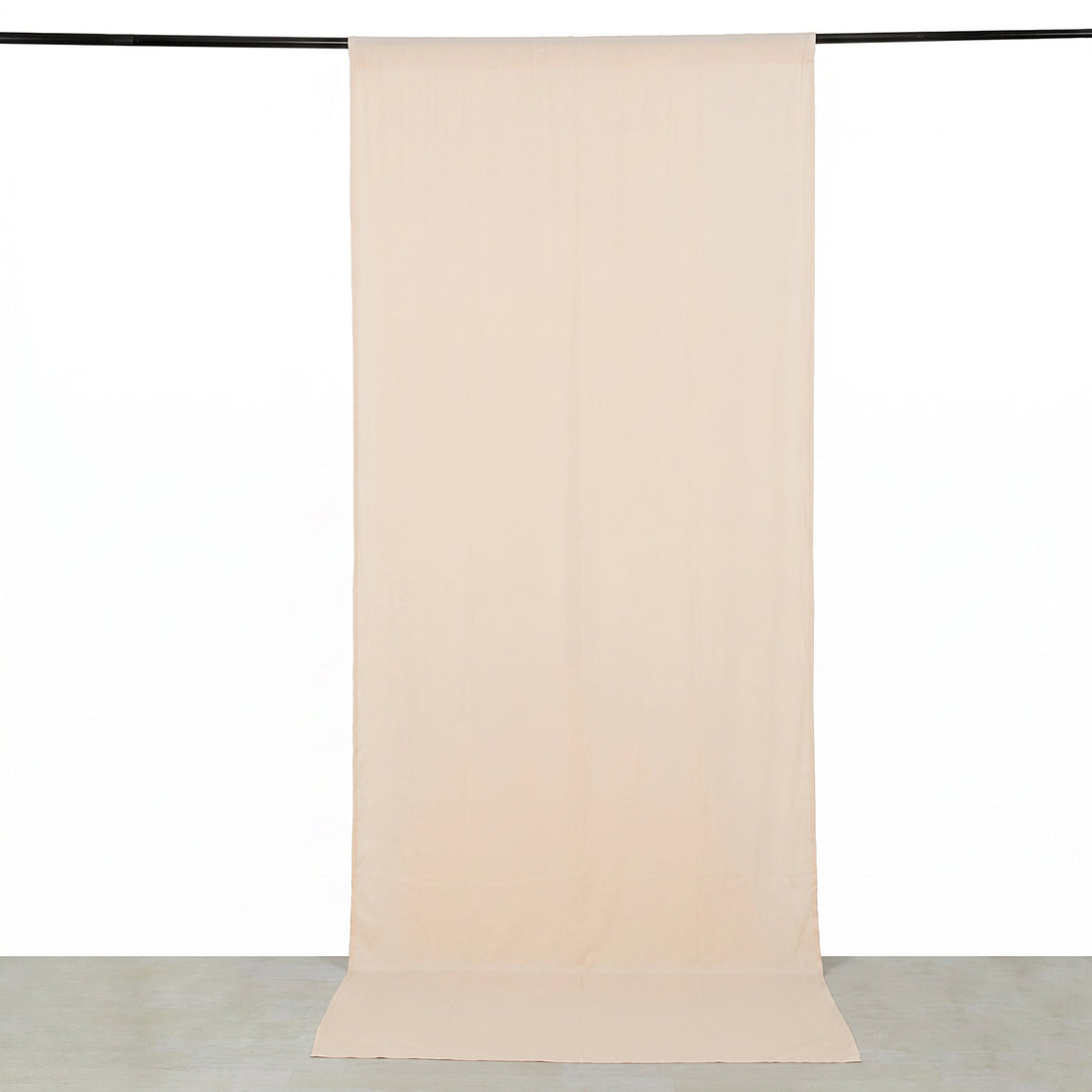 Beige sheer curtain panel hanging on a black rod, minimalist home decor