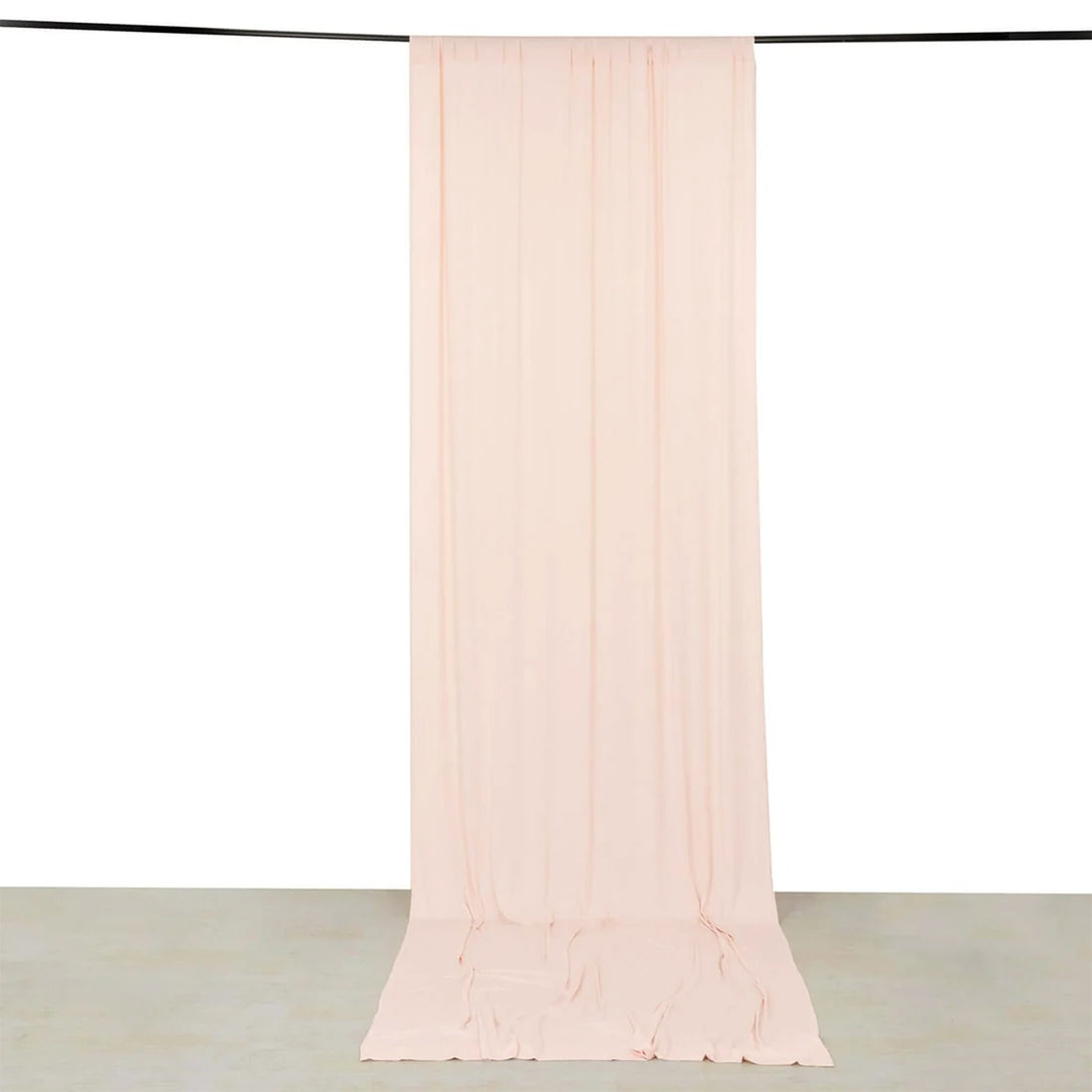 Sheer blush pink curtain panel hanging from a rod on white background