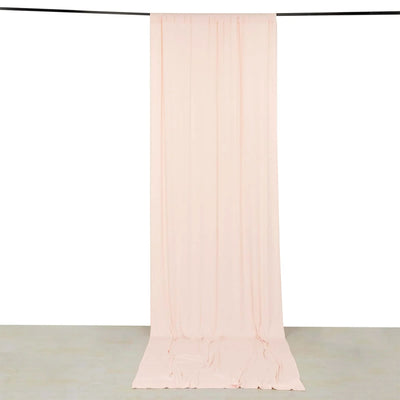 Sheer blush pink curtain panel hanging from a rod on white background