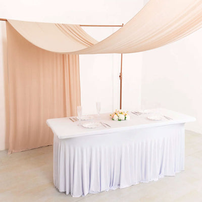 Elegant wedding table with blush draped canopy and floral centerpiece