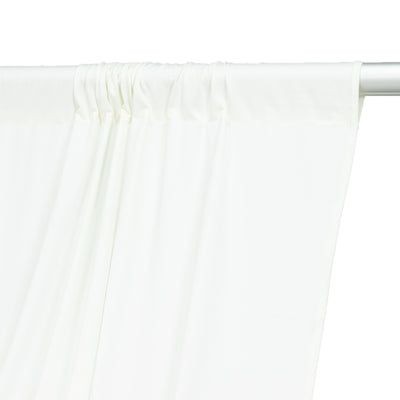White curtain fabric draped on a rod, showcasing smooth texture and flowing design.