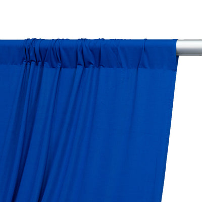 Blue fabric curtain draped on a rod, showcasing smooth texture and vibrant color.
