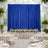 Elegant wedding reception setup with blue curtains and floral table decoration.