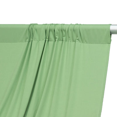 Green fabric draped elegantly, showcasing texture and color.
