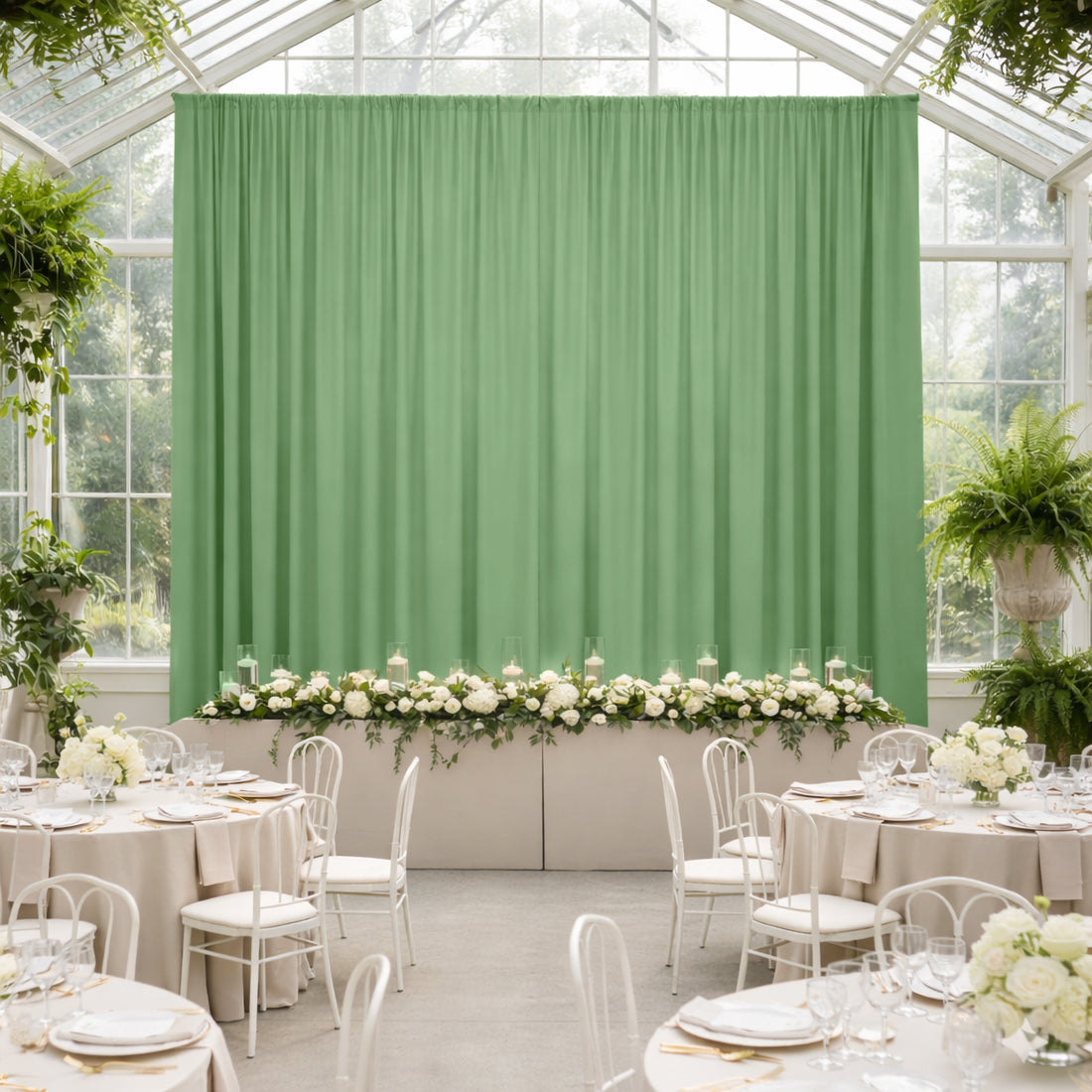 Elegant green backdrop with floral arrangement in a styled event setting.