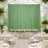 Elegant green backdrop with floral arrangement in a styled event setting.