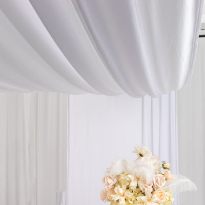 Elegant floral arrangement under soft white drapery