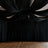 Black drapery ceiling installation in a spacious event venue.