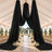Elegant black draped wedding tent with floral aisle and garden ceremony backdrop