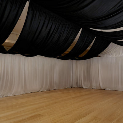 Elegant black and white drapery in a spacious event space.