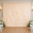 Elegant cream wedding backdrop with draped curtains and floral arrangements