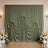 Elegant sage green draped wedding backdrop with white floral arrangements
