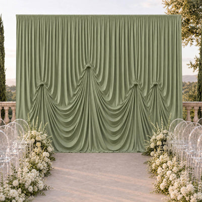 Elegant sage green draped wedding backdrop with white floral aisle decor