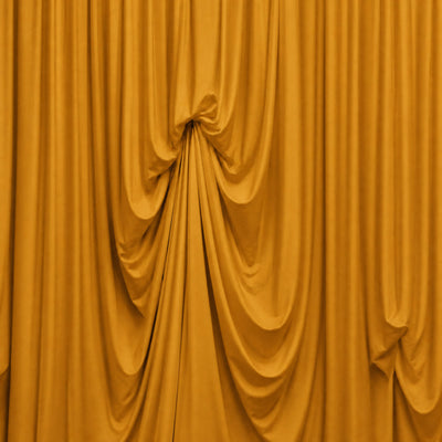 Golden draped curtains with flowing fabric folds and soft stage lighting