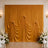 Golden draped wedding backdrop with white floral aisle decor