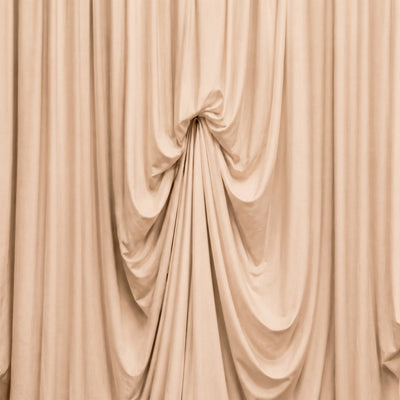 Beige draped curtains with elegant soft folds and fabric texture