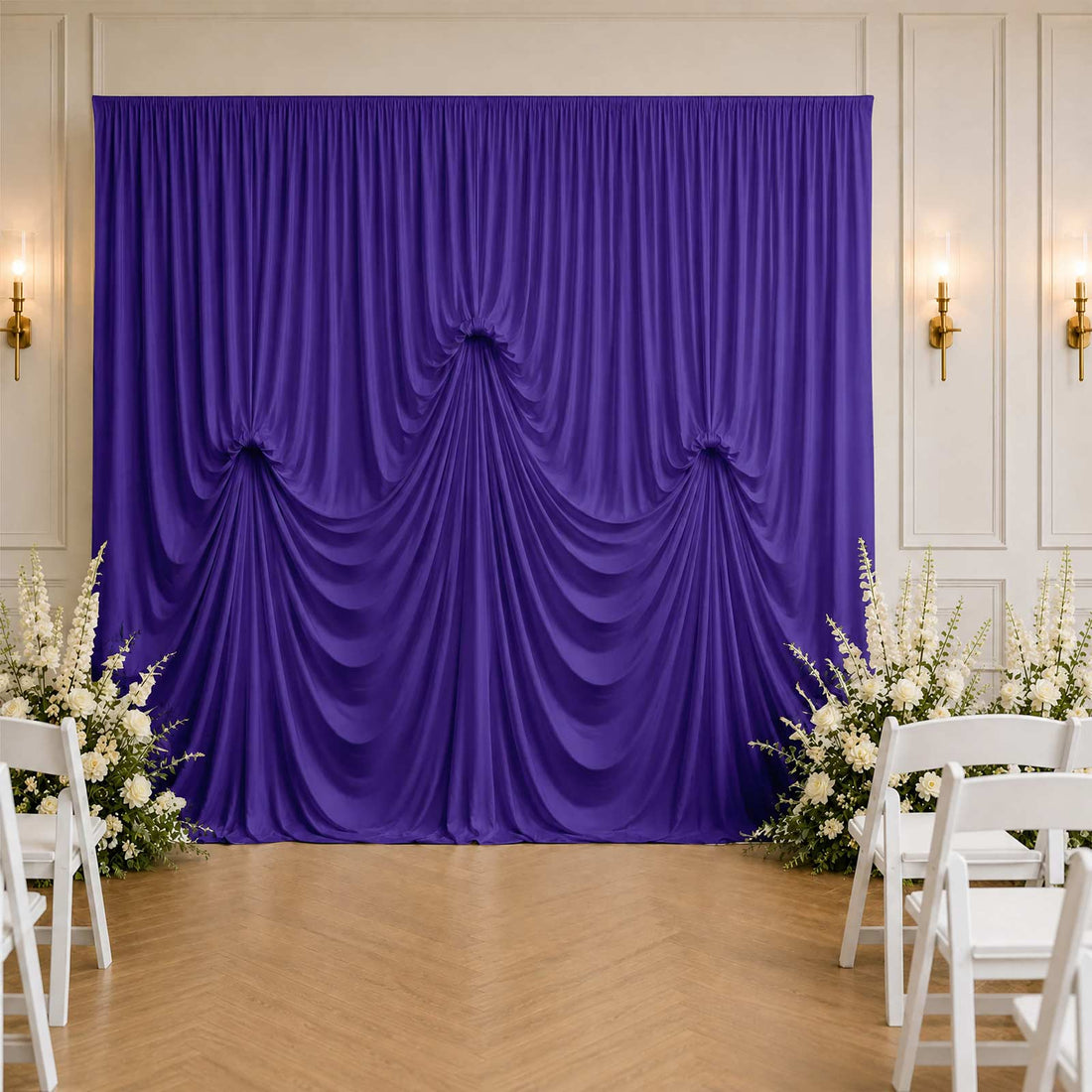 Elegant purple wedding backdrop with white floral arrangements and chairs