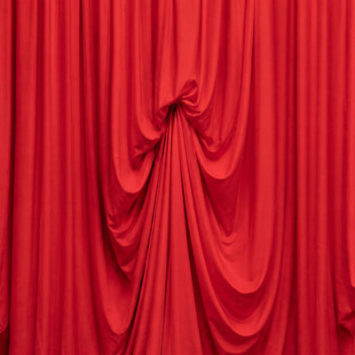 Red draped stage curtain background with elegant folds
