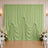 Mint green draped wedding backdrop with white floral arrangements and chairs