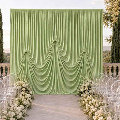 Elegant outdoor wedding ceremony backdrop with green draped curtain and white flowers