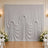 Elegant white draped wedding backdrop with floral arrangements and wall sconces
