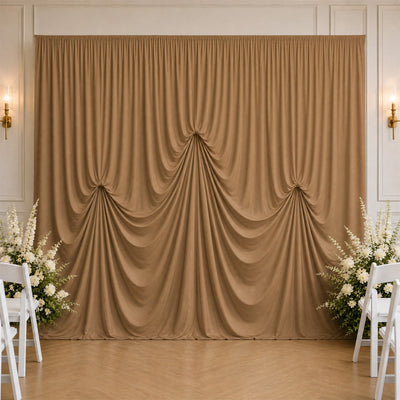 Elegant gold wedding backdrop with draped curtains and white floral arrangements
