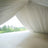 Elegant white draped fabric creating a soft, serene atmosphere in natural light.