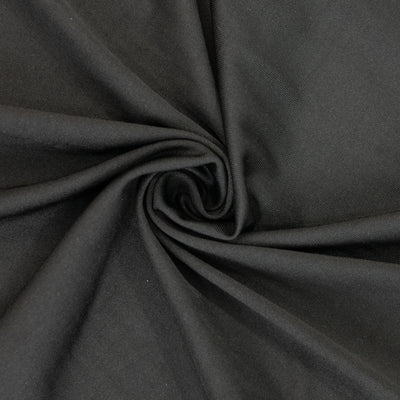 Black fabric swirled in a circular pattern, showcasing its texture and depth. #whtbkgd