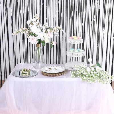 Elegant table setup with floral arrangements and decorative plates.