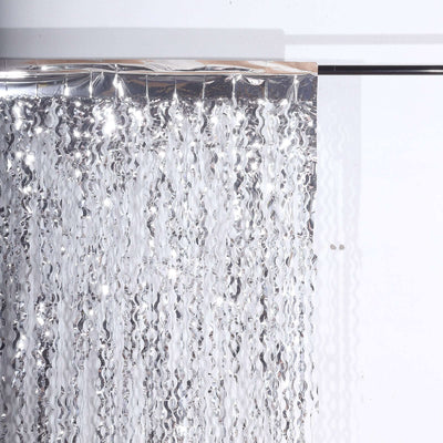 Silver metallic fringe curtain on a plain backdrop
