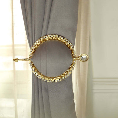Gold curtain tieback with decorative design, elegantly holding drapery in place.