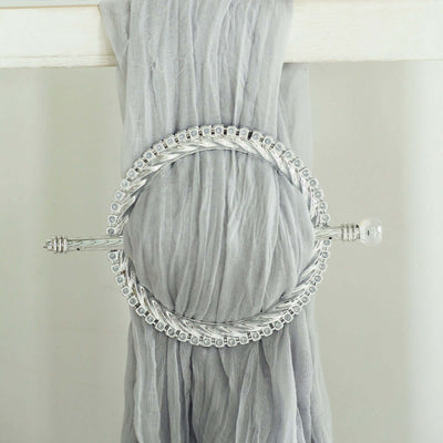 Silver circular scarf ring with intricate detailing.