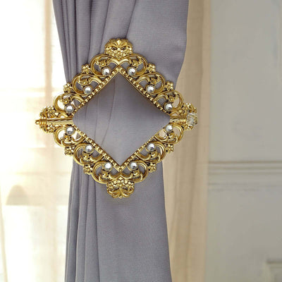 Elegant gold curtain tieback with intricate design and pearls.