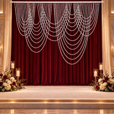 Elegant wedding stage with burgundy velvet backdrop and floral candle decor