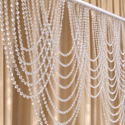Clear crystal bead curtain draped on a gold backdrop, elegant decor detail