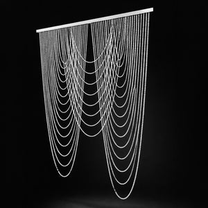 Beaded curtain with cascading strands on a sleek black backdrop.