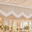 Elegant wedding reception ceiling decor with white draped fabric and crystal chandeliers