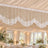 Elegant wedding reception with white draped ceiling and floral chandelier decor