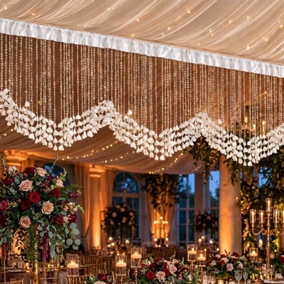 Elegant wedding reception decor with floral centerpieces and hanging white garlands