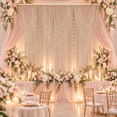Elegant blush and ivory wedding reception backdrop with floral decor and candles