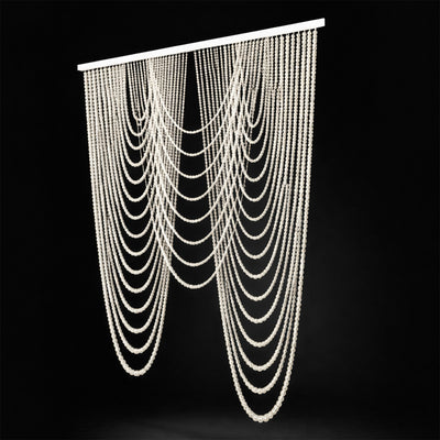 Beaded curtain with multiple cascading strands on a black background.