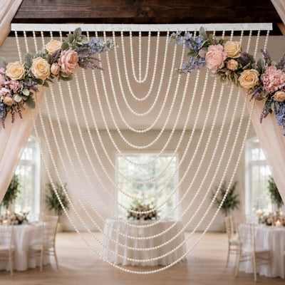 Elegant wedding arch with pearl drapes and pastel floral arrangement