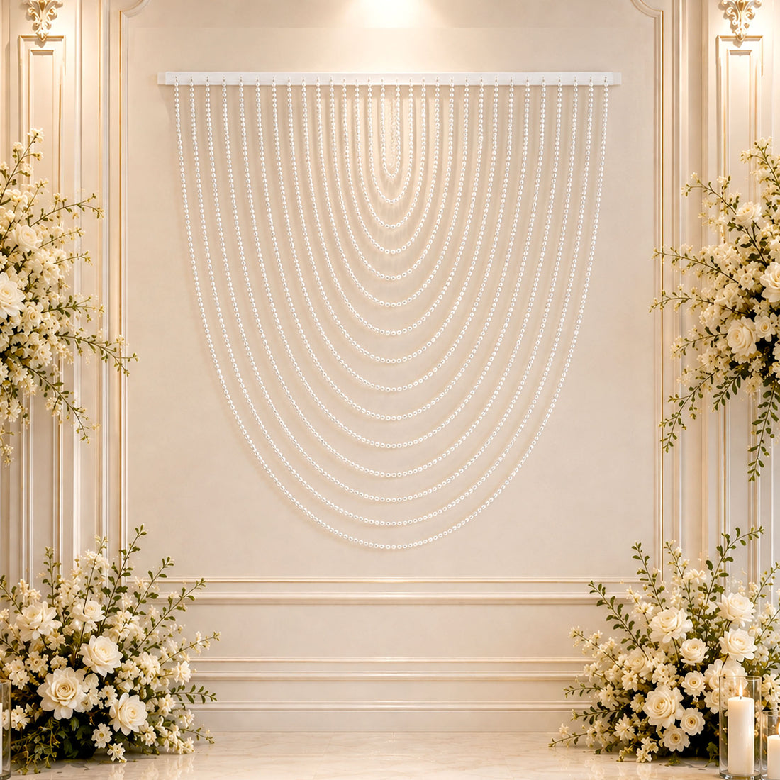 Elegant white floral wedding backdrop with pearl bead drapes and candles
