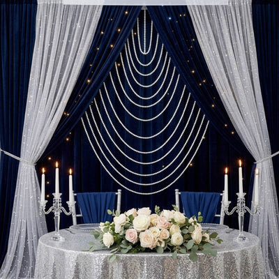 Elegant navy and silver wedding stage with pearls, candles, and floral centerpiece