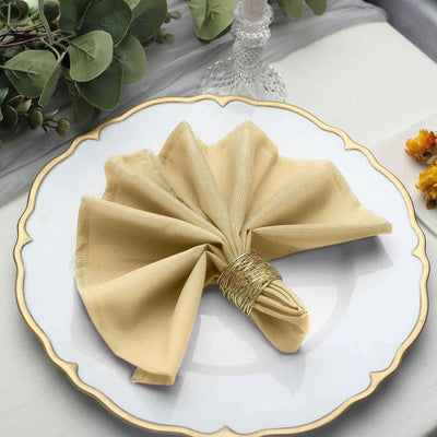 Elegant gold napkin elegantly folded on a decorative plate.